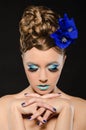 Vertical portrait of woman with blue make-up