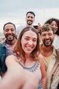 Vertical portrait of young adult multiracial friends taking a selfie together for the social mediaon a friendly Royalty Free Stock Photo