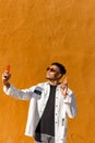 vertical portrait of a young black Latino boy with sunglasses taking a selfie Royalty Free Stock Photo