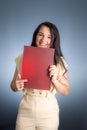 Vertical portrait of young businesswoman, lawyer, showing her business folder Royalty Free Stock Photo