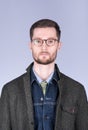 Vertical portrait of a young man with a beard and glasses in sty Royalty Free Stock Photo