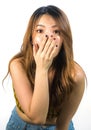 Vertical portrait of young shocked and surprised beautiful Asian Korean woman covering mouth with hand in disbelief and surprise Royalty Free Stock Photo