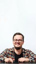 Vertical portrait of young smiling caucasian man on white background. Copy space. Man wearing eyeglasses, watch and casual denim Royalty Free Stock Photo