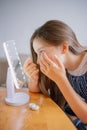 Vertical portrait Young woman trying to apply contact lenses in front of mirror. Young girl trying on new contact lenses. Close up Royalty Free Stock Photo