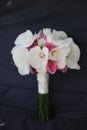 Vertical position of a bride bouquet with white orchids and pink roses Royalty Free Stock Photo