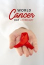 Vertical poster for World cancer day. Woman Hand holding red ribbon with text February, 4