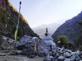 Vertical Prayer Flags, buddhist stupa and stone painted with Buddhist mantras in Himalayas