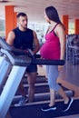 Pregnant woman during the third trimester running on treadmill