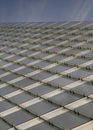 Vertical Puffy clouds at sunset Low angle view of a building with glass beams outside at Salt La Royalty Free Stock Photo