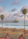 Vertical Puffy clouds at sunset View of slate shingle roofs of a cabins at Oceanside, California Royalty Free Stock Photo