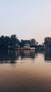 Vertical of a quaint village with a tranquil lake at sunset