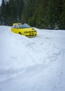 Vertical of a rally car on Levoca Rally driving on snow in a forest in Torysky, Slovakia.