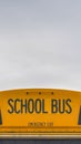 Vertical Rear of a yellow school bus with signal lights and emergency exit window Royalty Free Stock Photo