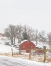 Vertical red barn in snow storm Royalty Free Stock Photo