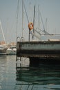 Vertical of a a rescue ring life buoy at boats moored at a harbor basin in Izola, Slovenia Royalty Free Stock Photo