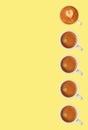 Row of Frothy Espresso Coffees Pattern on Yellow Background