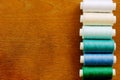 Vertical row of sewing thread spools Royalty Free Stock Photo