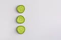 The vertical row of  slices of fresh green cucumber on a white studio background Royalty Free Stock Photo