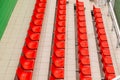 Vertical rows of bright orange spectator seats at stadium Royalty Free Stock Photo