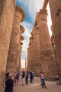 Vertical of the ruins of Egyptian temple complexes at Karnak and Luxor with sightseeing tourists Royalty Free Stock Photo