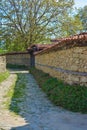 Vertical rural scene of walls and plants along the road in a town Royalty Free Stock Photo