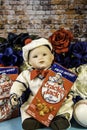 Vertical sailor doll holding vintage cracker jack box