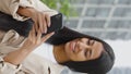 Vertical Screen: Young amiable black woman texting message and smiling