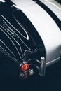 Vertical selective closeup shot of the taillight of a black and white car Royalty Free Stock Photo