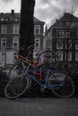 Vertical selective color of bicycles parked on the sidewalk in Osnabrueck, Germany Royalty Free Stock Photo