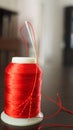 Vertical selective focus of a red spool of thread and a needle Royalty Free Stock Photo