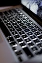 Vertical selective focus shot of black laptop keyboard