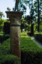Vertical selective focus shot of column in a park in Alcazar, Seville
