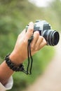 Vertical selective focus shot of a female hand holding a camera Royalty Free Stock Photo