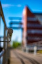 Vertical selective focus shot of a metallic object at the railway station