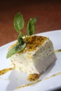 Vertical selective focus shot of vanilla cake with mango and chocolate sauce on white plate Royalty Free Stock Photo