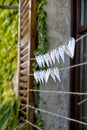 Vertical selective focus shot of wedding souvenirs hanging on threads Royalty Free Stock Photo