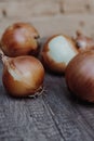 Vertical shallow focus closeup shot of white onions on a wooden table