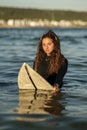 Vertical shallow focus shot of a young European surfer in water