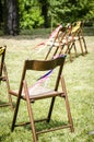 Vertical shallow focused shot of a wooden foldable chair with other chairs in the background