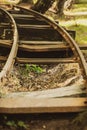 Vertical shot of an abandoned old railway track running through a forest Royalty Free Stock Photo