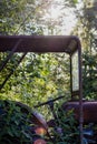 Vertical shot of an abandoned old rusty car in the forest Royalty Free Stock Photo