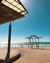 Vertical shot of an abstract sculpture on the sunny shore of Henley Beach in Australia