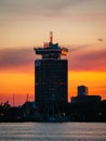 Vertical shot of Adam tower during scenic orange sunset, Amsterdam, Netherlands