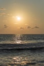 Vertical shot of an admirable sunset on a wavy sea Royalty Free Stock Photo