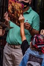 Vertical shot of an adult male and a kid holding the new album of the Spanish heavy band Mago de Oz