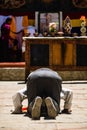 Vertical shot of an Adult Tibetan Buddhist worshiper in prostration at Tiji Festival in Lo Manthang