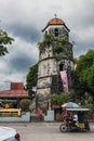 Vertical shot of an aged Christian bell tower church in the Philippines on a cloudy day