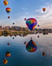 Vertical shot of air balloons in Prosser reflected in a river during the Washington balloon festival Royalty Free Stock Photo