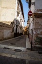 Vertical shot of an alleyway with old buildings in Xativa, Spain