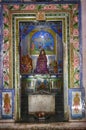Vertical shot of an altar at the Hindu temple with murals, religious characters and statues Royalty Free Stock Photo